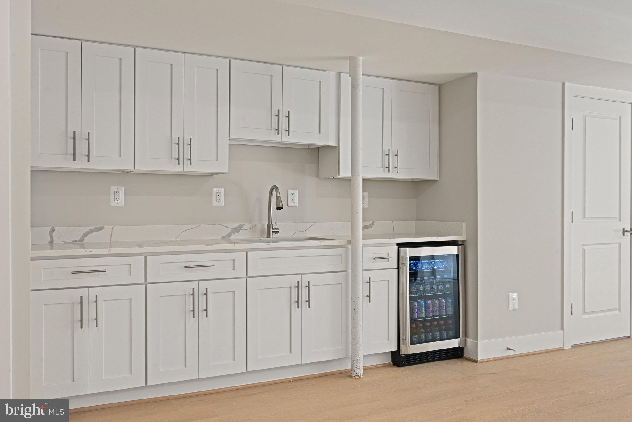 10900 Hunter Station Road Vienna, VA 22181 - Photo 80 of 110 a kitchen with white cabinets and a sink
