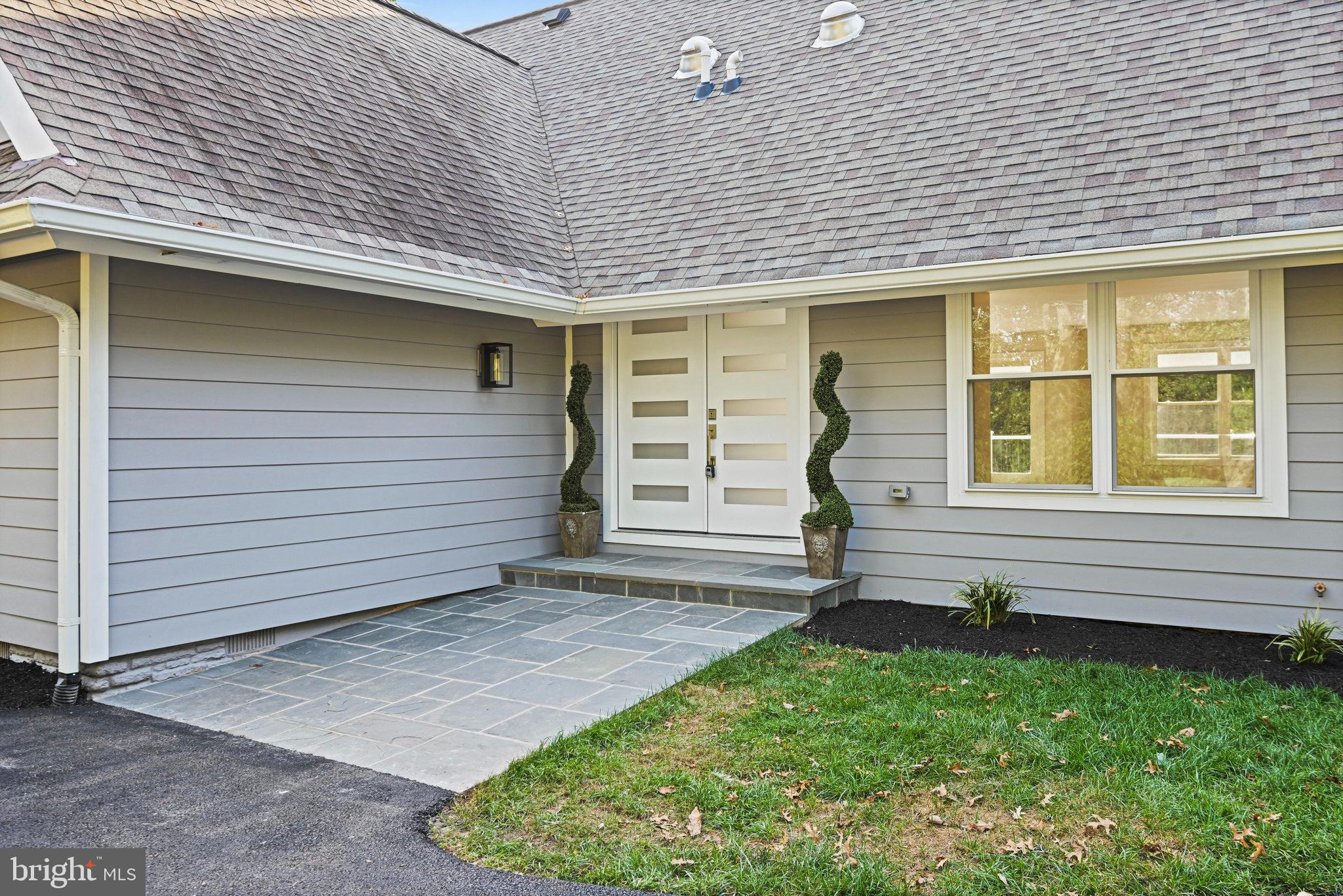 10900 Hunter Station Road Vienna, VA 22181 - Photo 83 of 110 a front view of a house with a garden