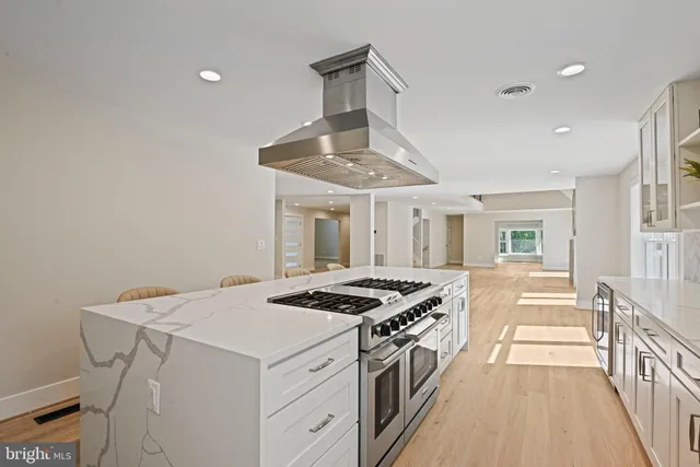 a view of empty room with wooden floor and fireplace