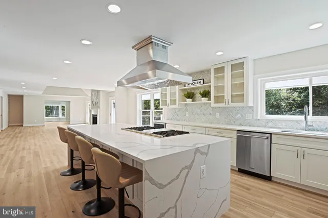 a view of a livingroom with wooden floor and a fireplace