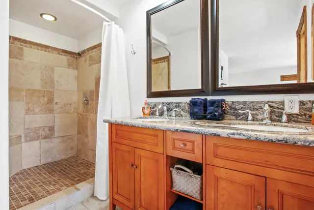 a living room with furniture a flat screen tv and a floor to ceiling window