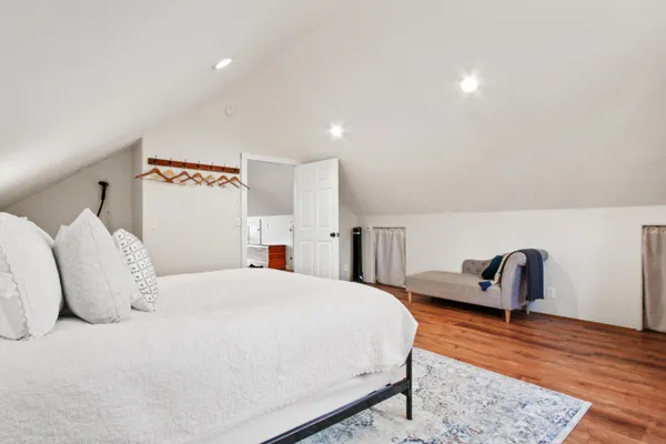 a living room with furniture a flat screen tv and a floor to ceiling window