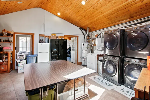 a living room with furniture a rug and a floor to ceiling window