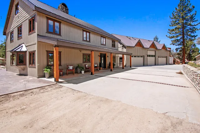 a living room with furniture a large window and a rug
