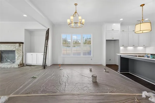 a large kitchen with kitchen island a large counter space a sink a window and stainless steel appliances