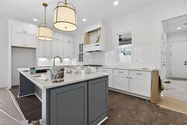 a bathroom with a tub a sink a window and a shower