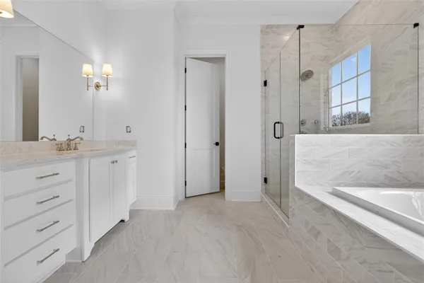 a bathroom with a granite countertop toilet sink and mirror