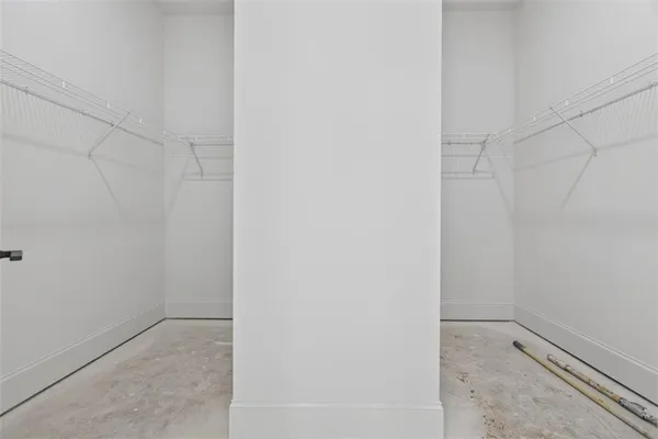 an empty room with a windows and ceiling fan