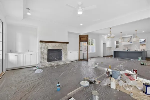 a living room with kitchen island furniture and a chandelier
