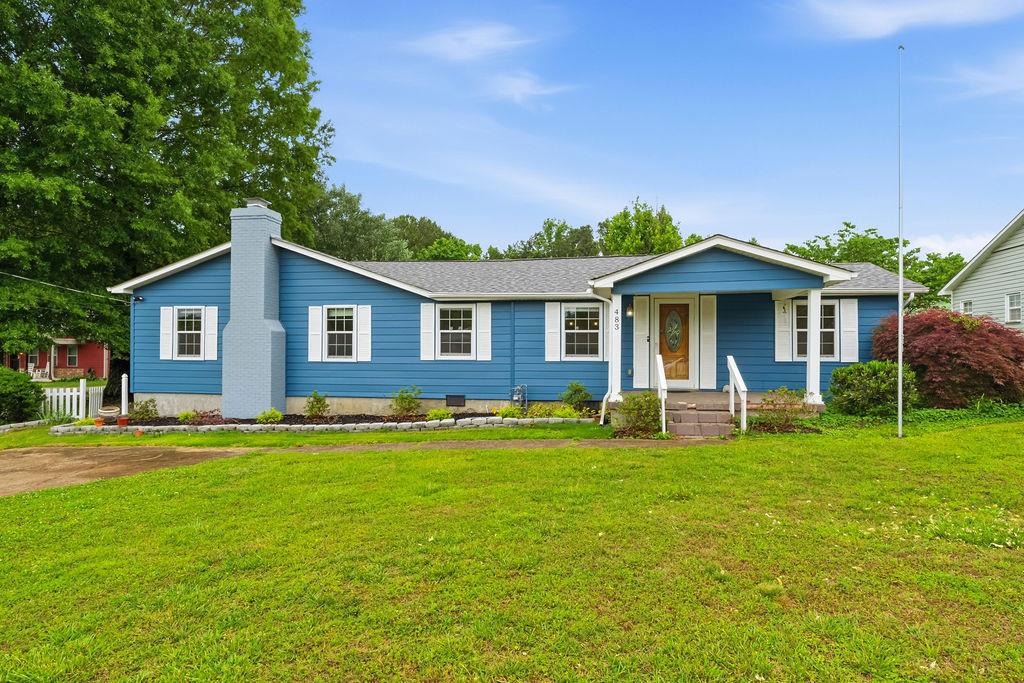 a front view of a house with a yard porch and outdoor seating