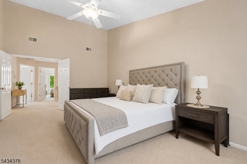 606 Park Place Springfield, NJ 07081 - Photo 13 of 21 a bedroom with a bed and a chandelier
