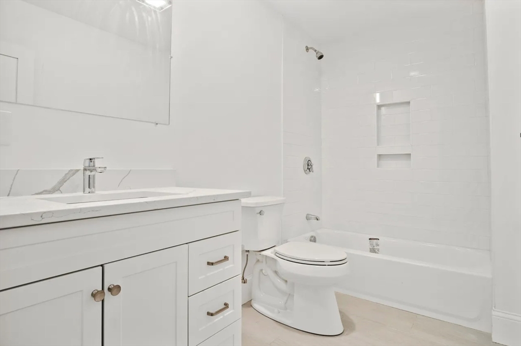 10 Sutton Street Boston, MA 02126 - Photo 11 of 24 a bathroom with a sink toilet and shower