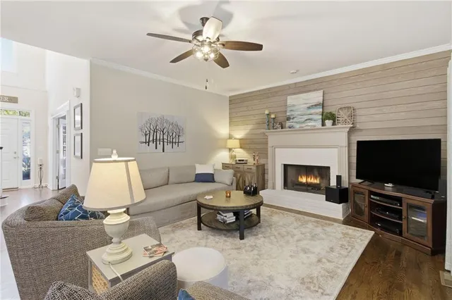 a living room with furniture a fireplace and a flat screen tv