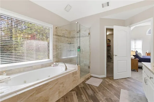 a spacious bathroom with a bathtub and a shower
