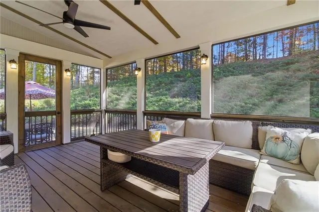a living room with furniture and a floor to ceiling window