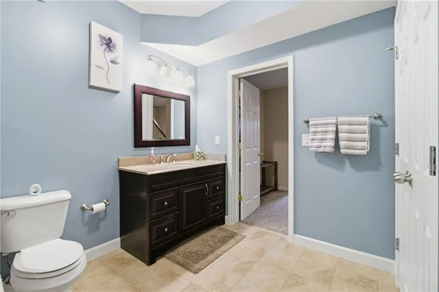 a bathroom with a toilet sink shower and mirror