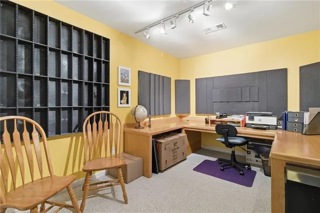 a view of a workspace with furniture and a book shelf
