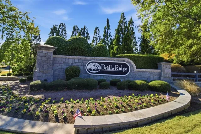 a view of a sign board with lots of green space