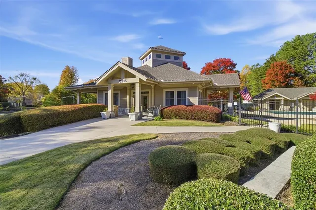 a front view of a house with yard and green space