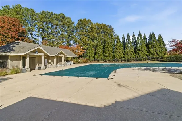 a view of a white house with a yard and large tree