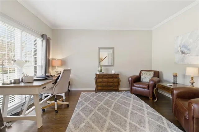 a bedroom with furniture and a large window