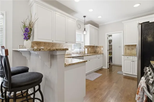 a kitchen with a sink cabinets and refrigerator