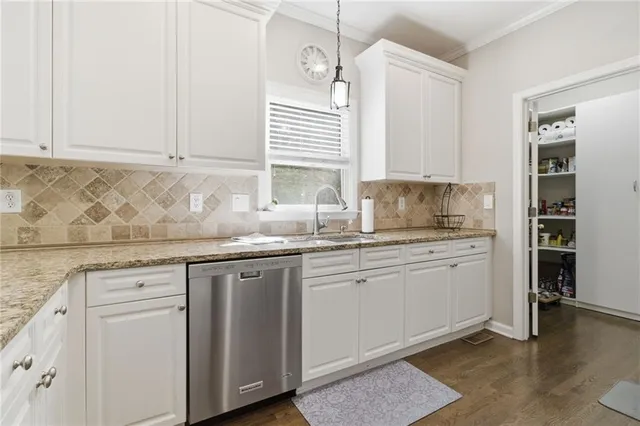 a kitchen with granite countertop white cabinets and white appliances