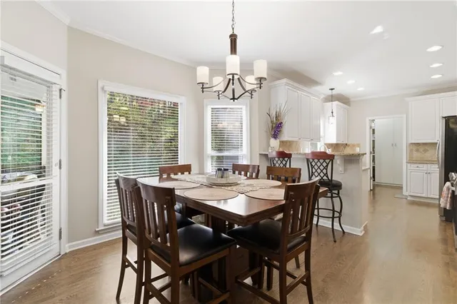 a view of a dining room with furniture window and wooden floor