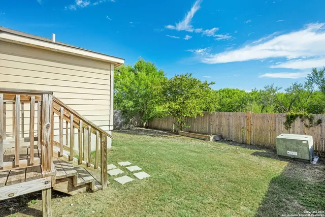 a bathroom with a small yard and large tree