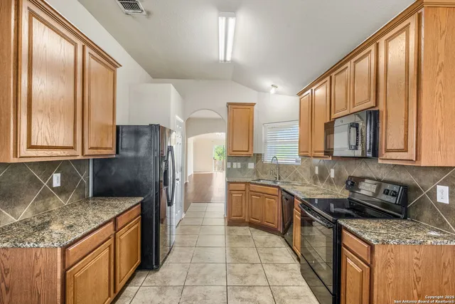 a kitchen with stainless steel appliances granite countertop counter space a sink and cabinets