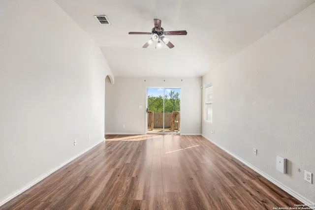 wooden floor in an empty room with a window