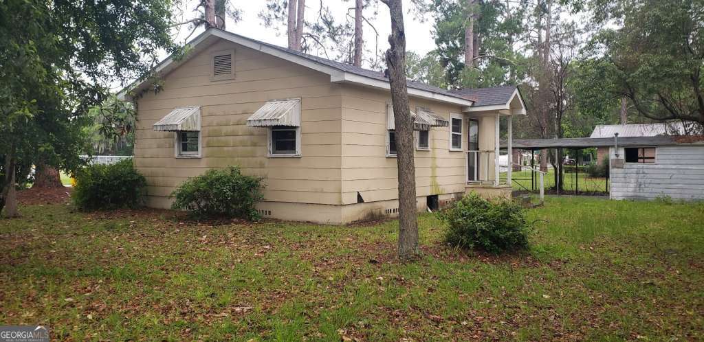 1219 Clough Street Waycross, GA 31501 - Photo 1 of 10 a view of a house with a yard
