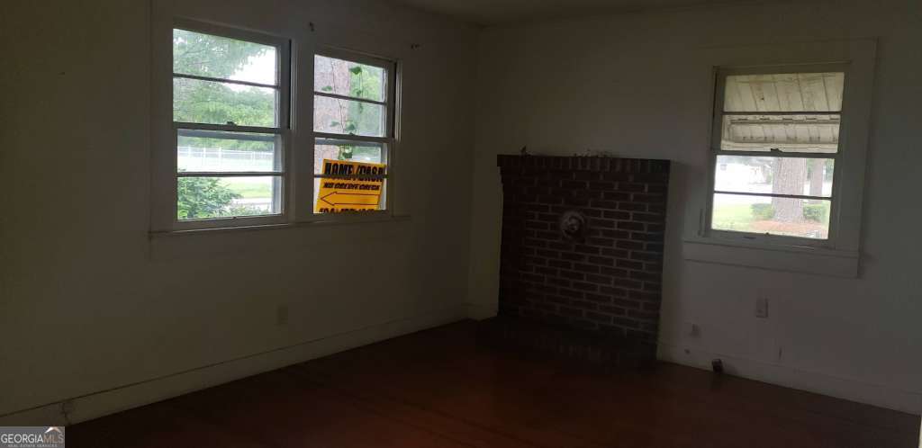 1219 Clough Street Waycross, GA 31501 - Photo 3 of 10 an empty room with windows