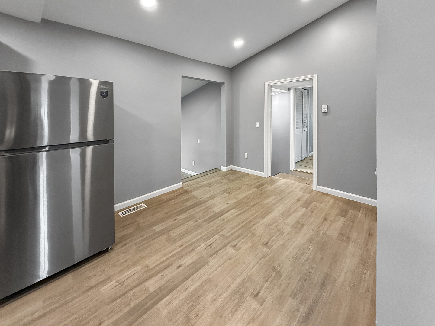 302 West Cook Street Sheffield, IL 61361 - Photo 8 of 18 a view of a refrigerator in kitchen and wooden floor