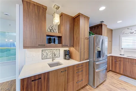 a kitchen with stainless steel appliances a refrigerator and a sink