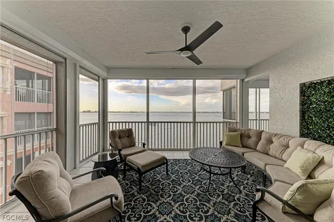 a living room with furniture and a floor to ceiling window