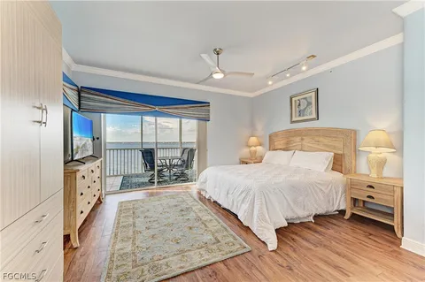 a bedroom with a large bed and a large window
