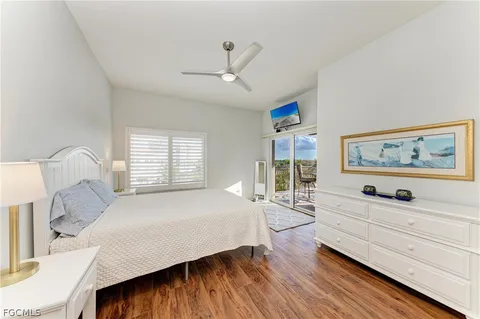 a bedroom with a bed and a refrigerator