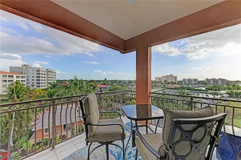 a balcony view with a large window and sitting space