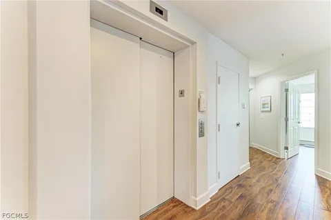 a view of a hallway with wooden floor