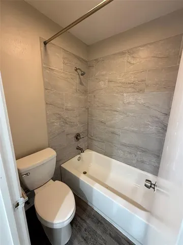 a bathroom with a toilet and a bathtub