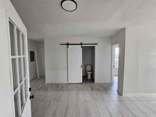a view of hallway with wooden floor