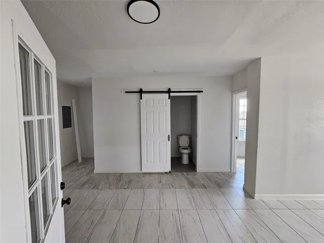 a view of hallway with wooden floor