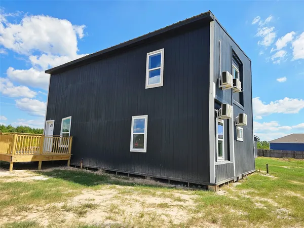 a view of an house with backyard space and balcony