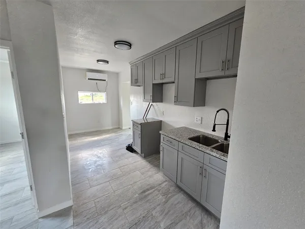 a kitchen with stainless steel appliances a sink stove and cabinets