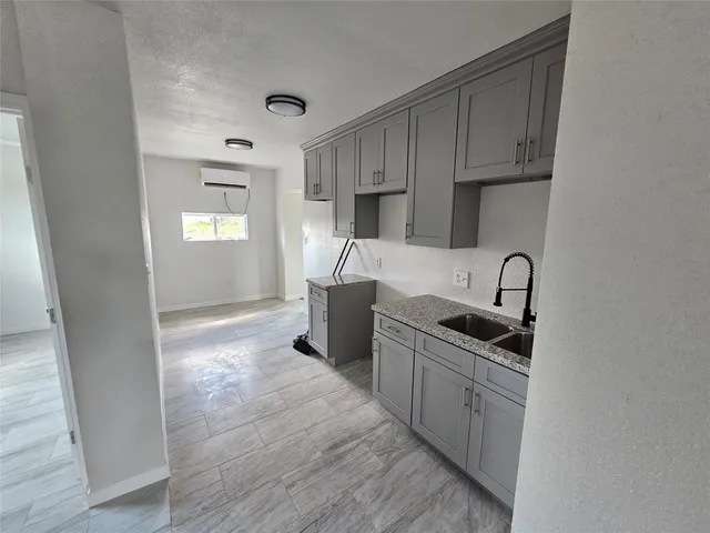 a kitchen with stainless steel appliances a sink stove and cabinets