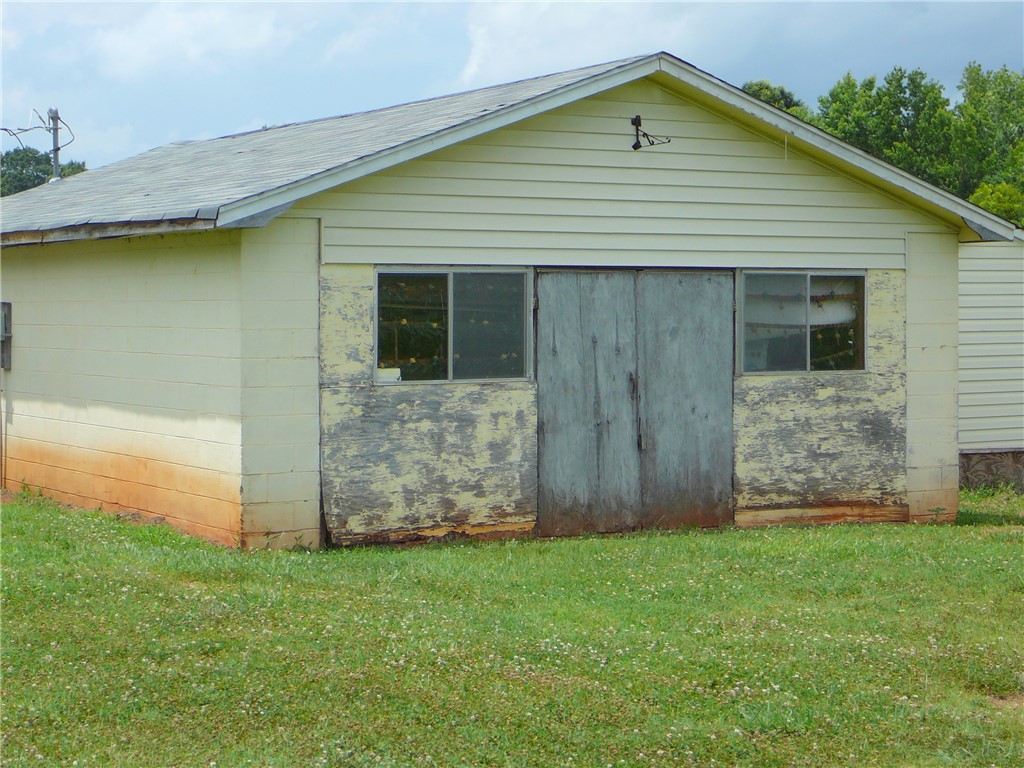1430 Grady Hall Road Anderson, SC 29626 - Photo 4 of 14 An aged utility building features weathered siding and a sturdy roof.
