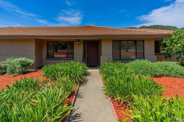 a front view of a house with garden