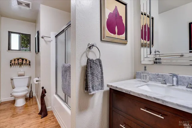a bathroom with a sink a vanity and a toilet
