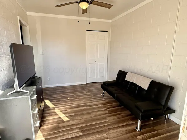 a living room with furniture and a flat screen tv